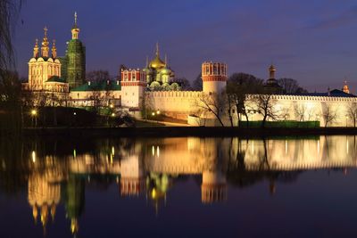 Reflection of buildings in city at night