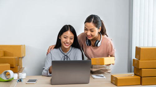 Young woman using laptop while sitting at home