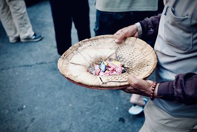 Low section of man standing on street