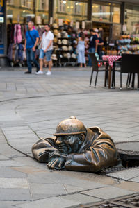 Male statue in manhole