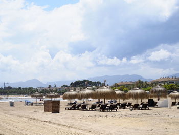 View of cows on beach against sky