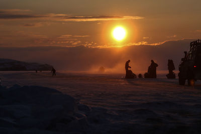 Silhouette of people on beach during sunset