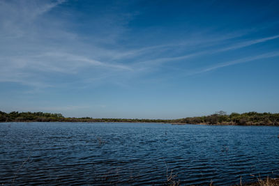 Scenic view of lake against blue sky