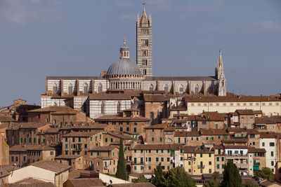 View of buildings in city against sky