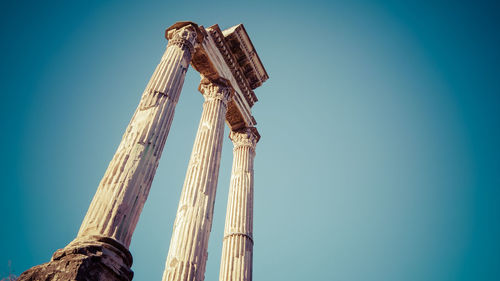 Low angle view of old ruins against clear blue sky