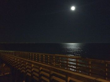 Scenic view of sea against clear sky at night