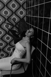 High angle view of young woman sitting in cage