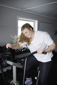 Blond woman exercising in gym