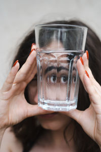 Cropped hand of woman holding drink