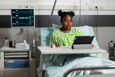 Young woman using laptop at table