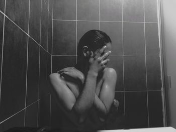 Young man playing in bathroom at home