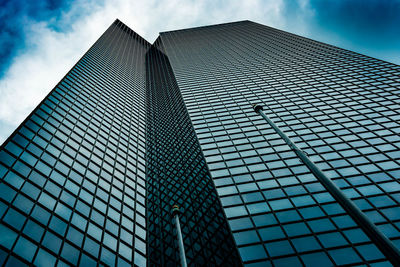 Low angle view of modern building against blue sky