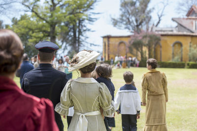 Rear view of people standing outdoors