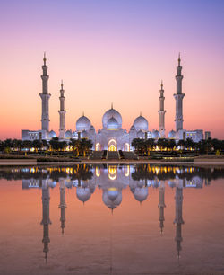 Sunset reflection of grand mosque on tranquil waters