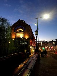 Illuminated building against sky at night