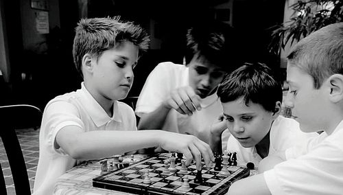 Side view of boys playing on table