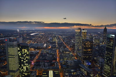 High angle view of city lit up at night