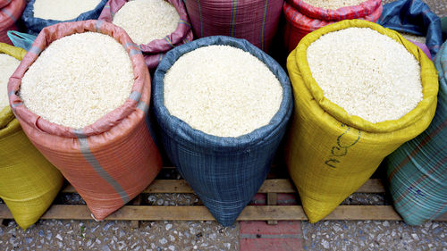 High angel view of rice in colorful pastel sack at fresh local market in luang prabang, laos