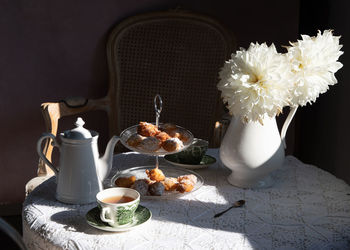 Tea break in english style, vintage still life, homemade buns, a bouquet dalias