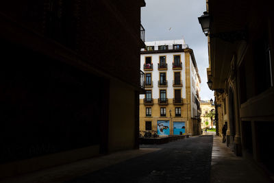 Narrow street amidst buildings against sky