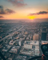 Aerial view of cityscape against sky during sunset