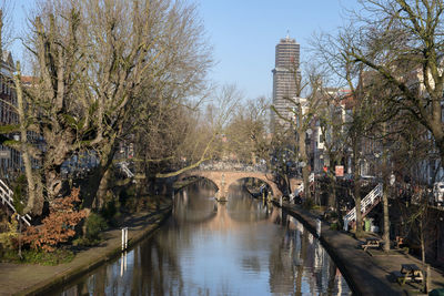 Bridge over river in city against sky