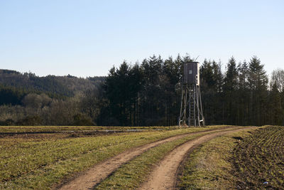 Scenic view of agricultural field against clear sky