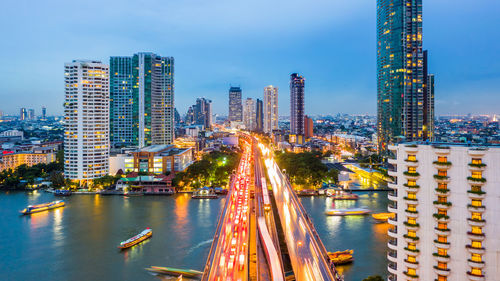 Panoramic view of illuminated city buildings against sky