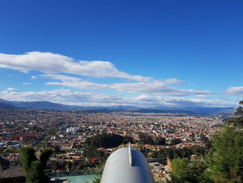 High angle view of city against blue sky