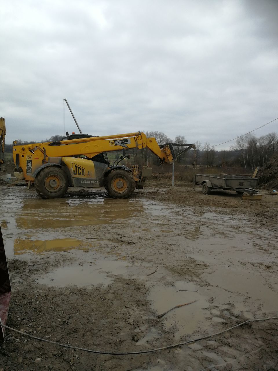 sky, cloud - sky, mud, construction site, outdoors, no people, day, construction machinery, transportation, tire, construction vehicle, puddle, industry, nature