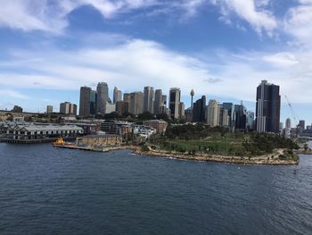 River amidst buildings in city against sky