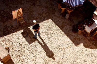 Man and his shadow in a courtyard