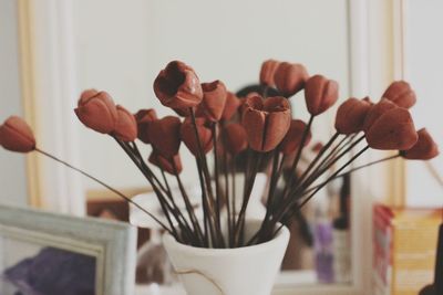 Close-up of flowering plant in vase on table at home