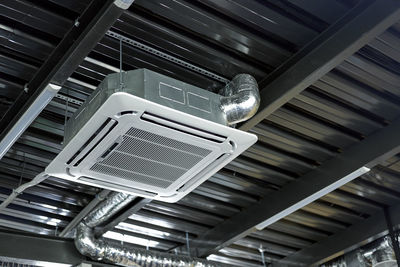 Low angle view of electric lights on ceiling