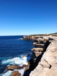 Scenic view of sea against clear blue sky