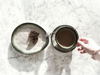 High angle view of hand holding drink