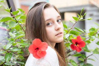 Portrait of woman with red flower