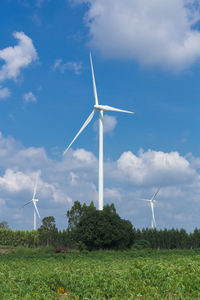 Windmill on field against sky