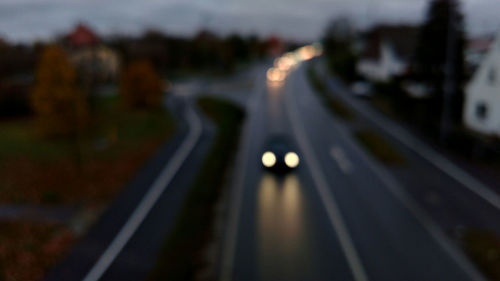 Defocused image of highway against sky at night