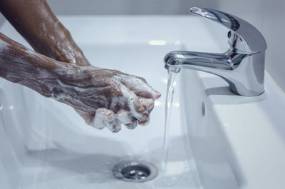 Close-up of person hand in water