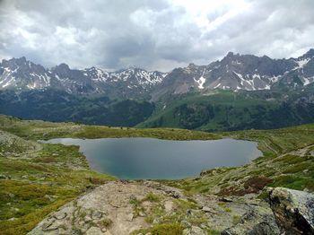 Scenic view of lake and mountains against sky