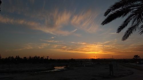 Scenic view of beach against sky during sunset