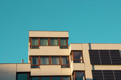 Low angle view of buildings against clear blue sky