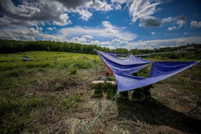 Scenic view of tent on field against sky