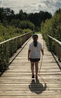 Rear view of woman on footpath