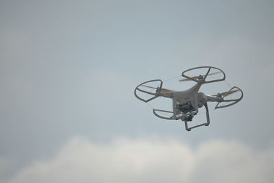 Low angle view of drone against sky