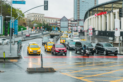 Traffic on road by buildings in city