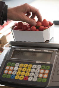 Cropped hand of man using calculator