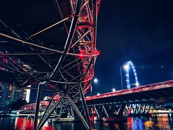 Low angle view of illuminated bridge at night