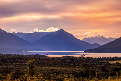 Scenic view of snowcapped mountains against sky during sunset